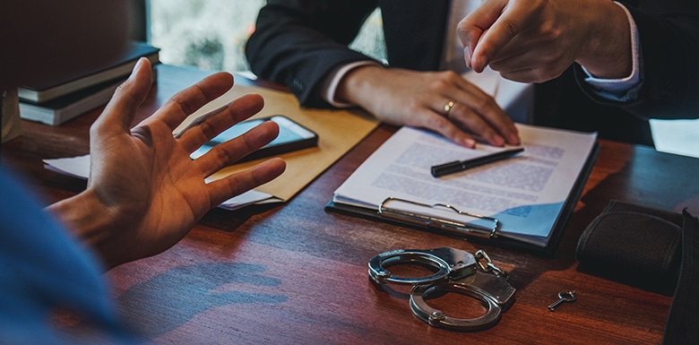 man pointing finger at another over desk