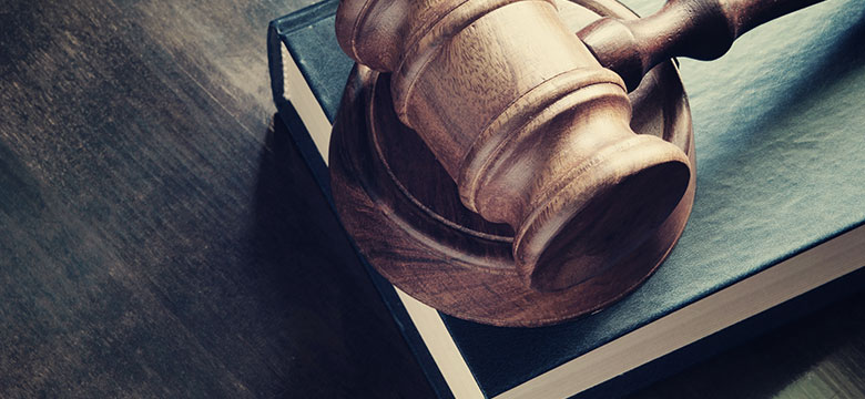 wooden gavel sitting on book