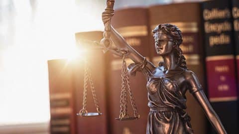 justice statue near books