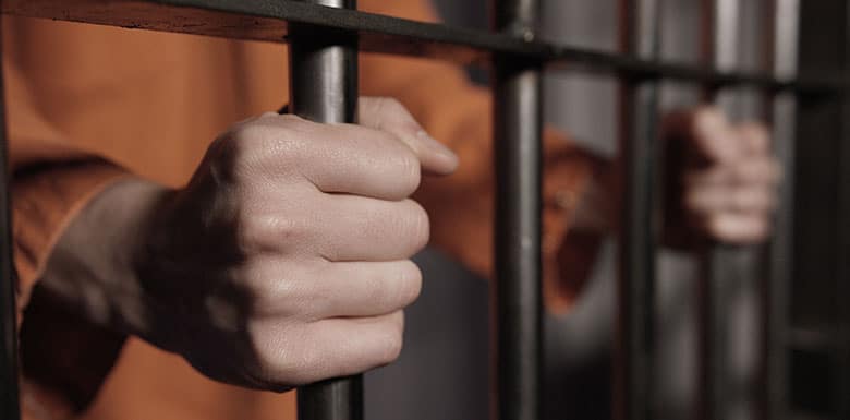 man holding bars of cells