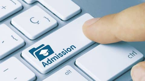 Computer button with the word "admission" on it