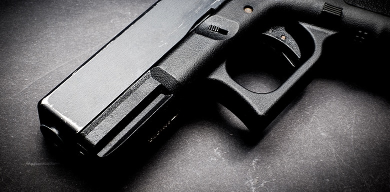 Black handgun on table