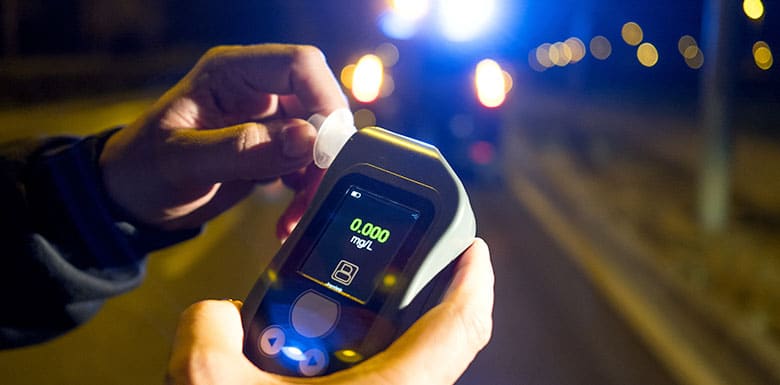 man holding breathalyzer