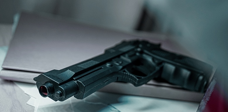 Hand gun sitting on paper in open drawer