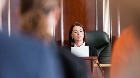 Woman in court reading paper