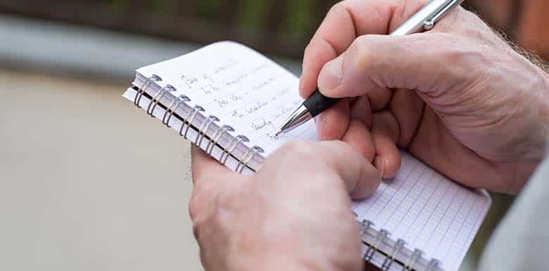 Drug crime investigator taking notes down with pen