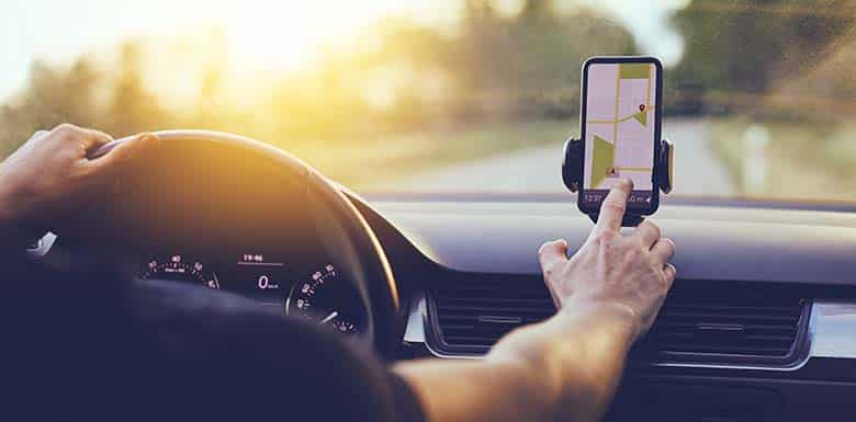 Man using mounted cell phone while driving